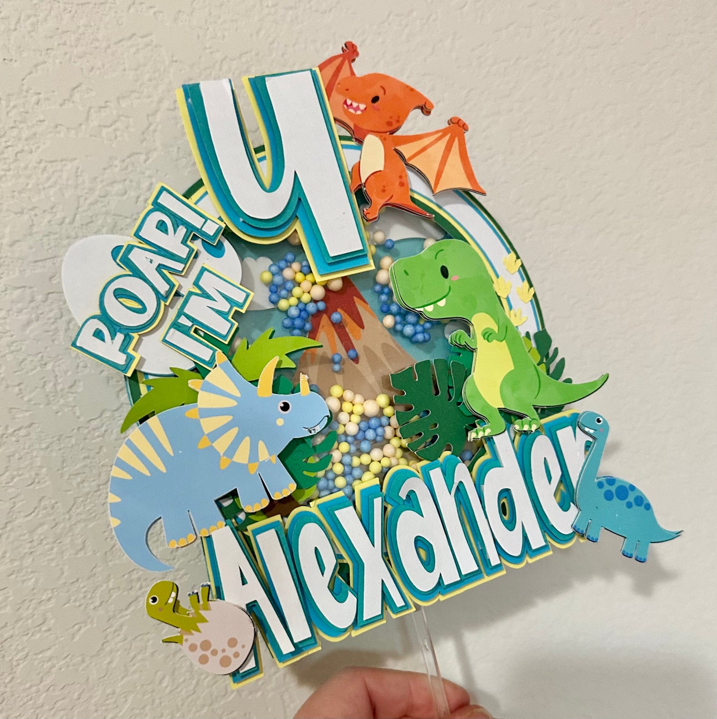Custom dinosaur "Roar Im 4" cake topper with greens and blue dinosaurs and colors
