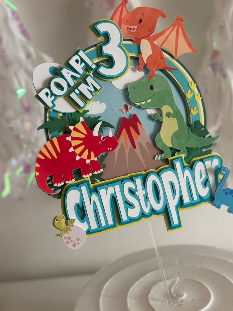 Custom dinosaur "Roar Im 3" cake topper with green red and orange dinosaurs